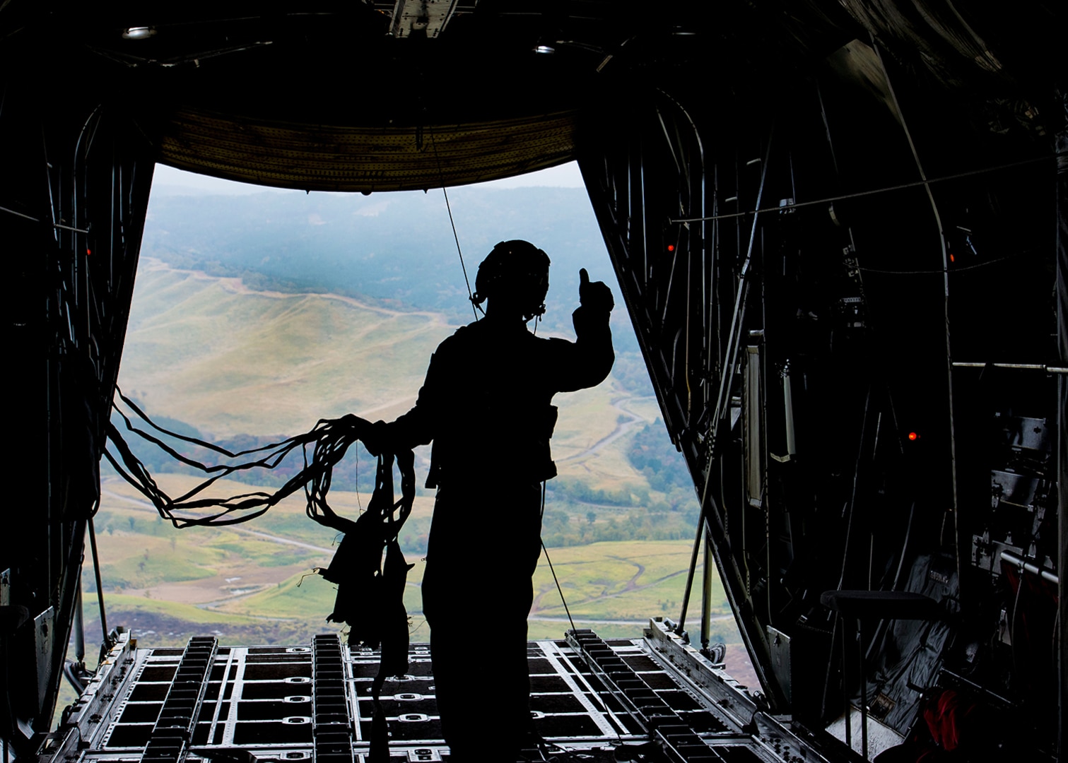 Senior Airman Anthony Schoof, 36th Airlift Squadron C-130 Hercules loadmaster, observes Japan Ground Self-Defense Force container delivery system bundles parachute to a drop zone during Keen Sword 2017, Nov. 10, 2016, over the Kyushu prefecture, Japan. Keen Sword is designed to practice the critical capabilities to support the defense of Japan, and to respond to a potential crisis or contingency in the Indo-Asia-Pacific region.