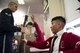 Senior Airman Angelo Hightower, U.S. Air Force Honor Guard Drill Team member, lets a La Salle Academy student hold his drill rifle during a school visit in New York, Nov. 10, 2016. The rifles are approximately 12 pounds and have dull bayonets attached at the end. (U.S. Air Force photo by Senior Airman Philip Bryant)