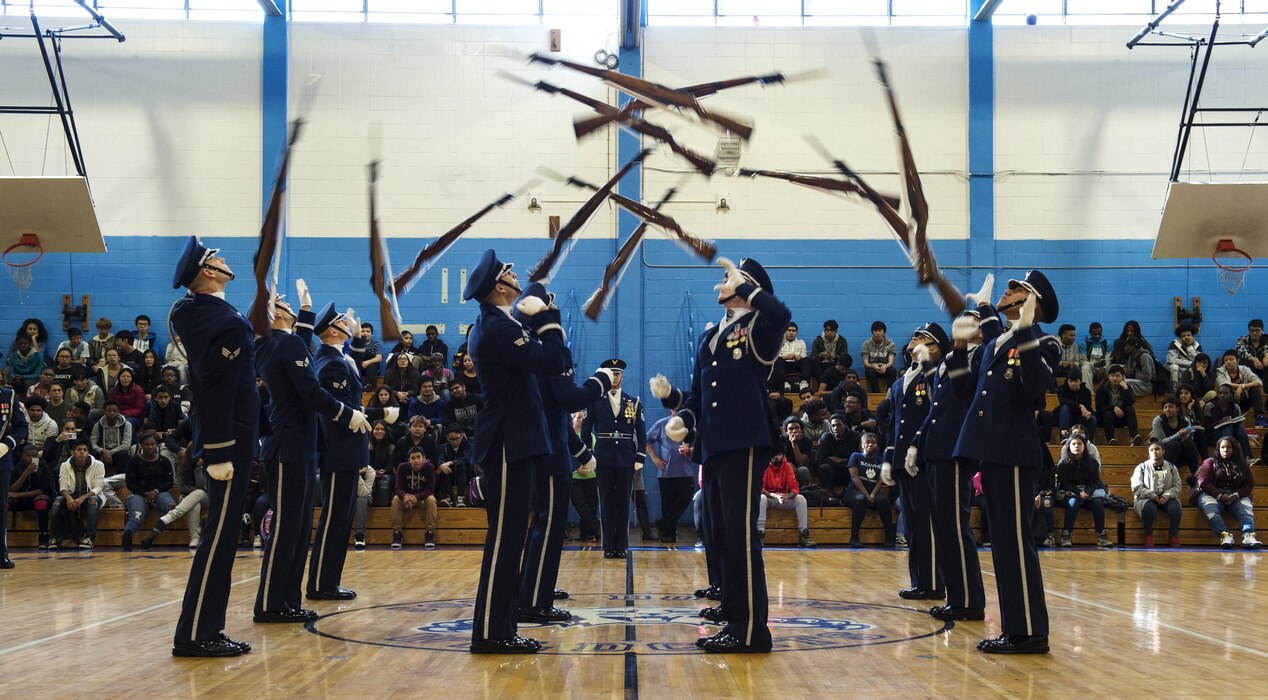 Members of the U.S. Air Force Honor Guard Drill Team perform a 12-man routine in front of Bowne High School students during a school visit in New York, Nov. 10, 2016. The Honor Guard took time to visit two high schools while in New York for America’s Parade for Veterans Day. (U.S. Air Force photo by Senior Airman Philip Bryant)