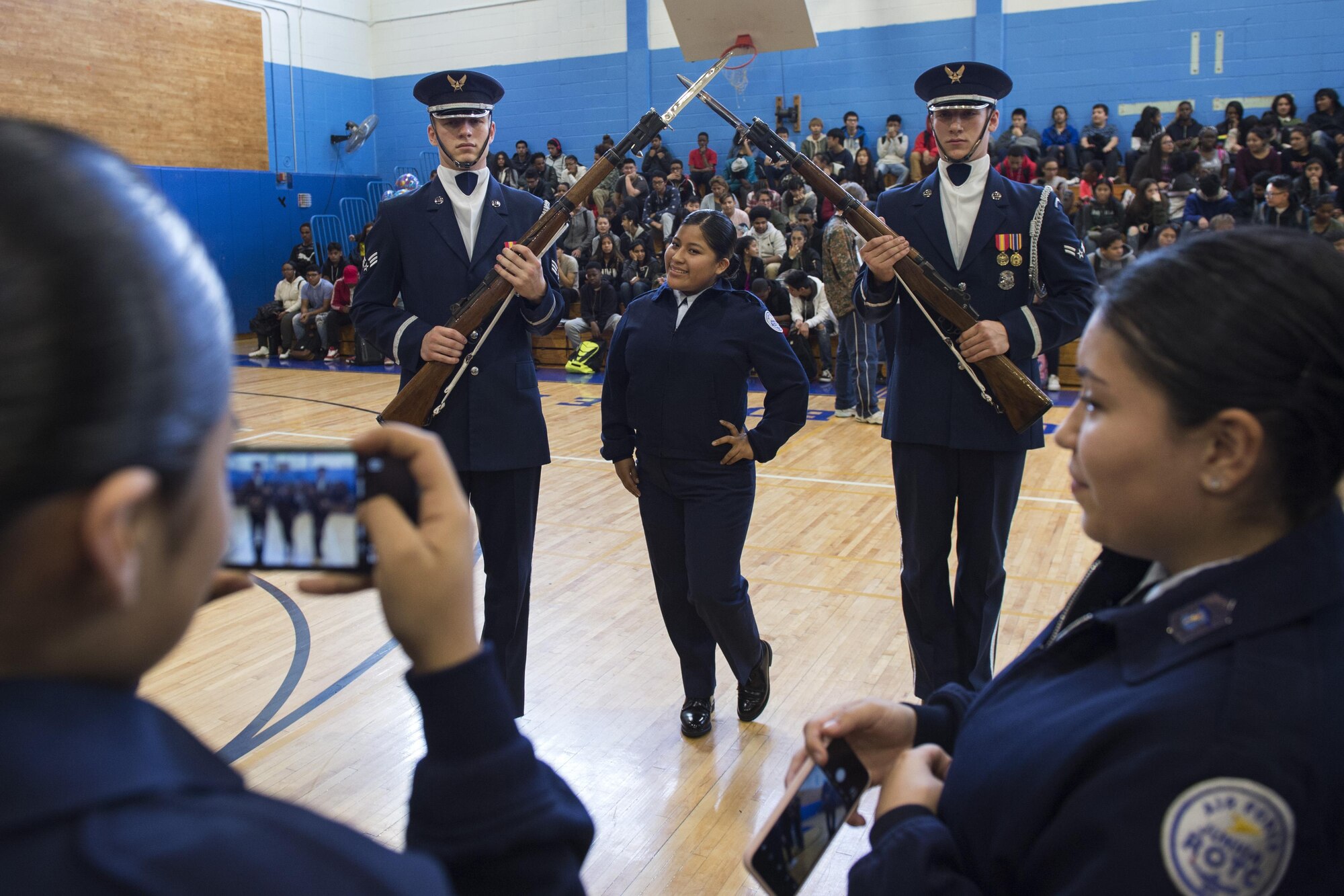 Air Force Junior ROTC students from Bowne High School take photos with U.S. Air Force Honor Guard Drill Team members students during a school visit in New York, Nov. 10, 2016. The drill team had the chance to take photos, answer questions and interact with some of the high school’s junior ROTC students. (U.S. Air Force photo by Senior Airman Philip Bryant)