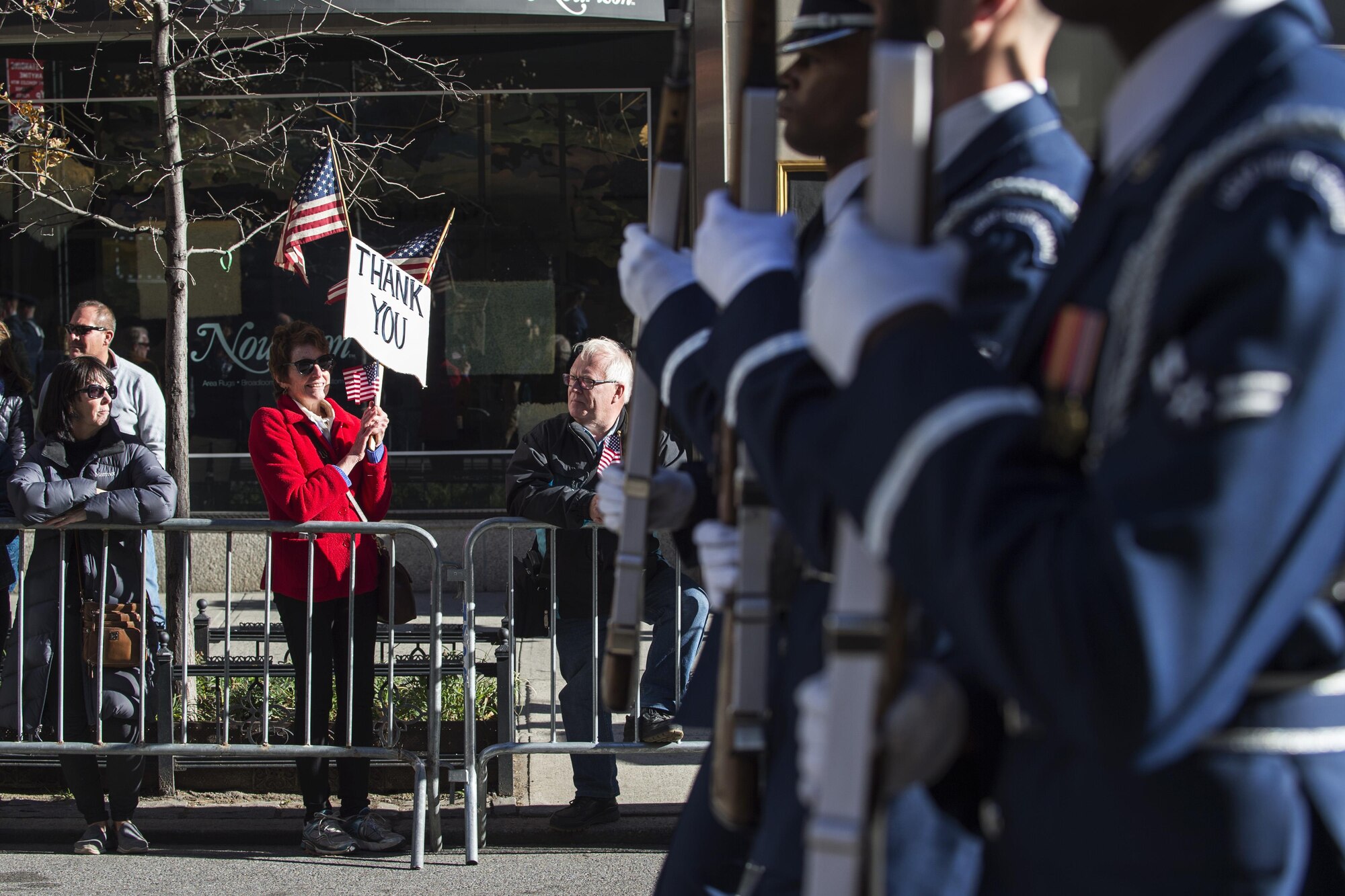 A parade viewer holds a sign of thanks while the U.S. Air Force Honor Guard march in the 2016 America’s Parade on Veterans Day down Fifth Avenue in Manhattan New York, Nov. 11, 2016. The parade had thousands of viewers lining Fifth Avenue with American flags and signs showing their support of past and present veterans. (U.S. Air Force photo by Senior Airman Philip Bryant)