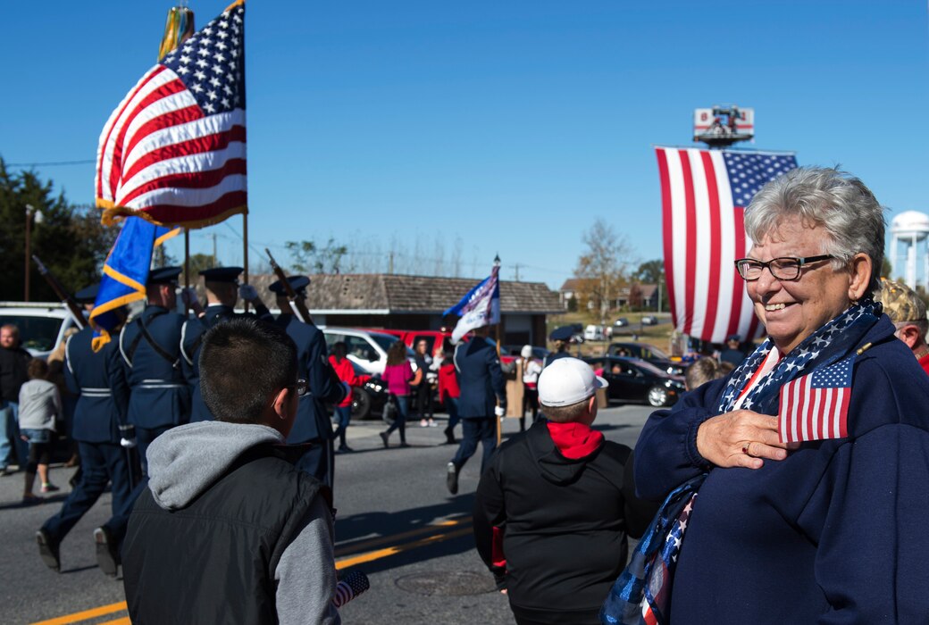 A parade viewer smiles while the U.S. Air Force Honor Guard march in the 4th Annual Veterans Day Parade in Laurel, Del., Nov. 12, 2016. The parade included veterans from other eras, members of the Delaware Army National Guard, and vintage military vehicles. (U.S. Air Force photo by Senior Airman Philip Bryant)