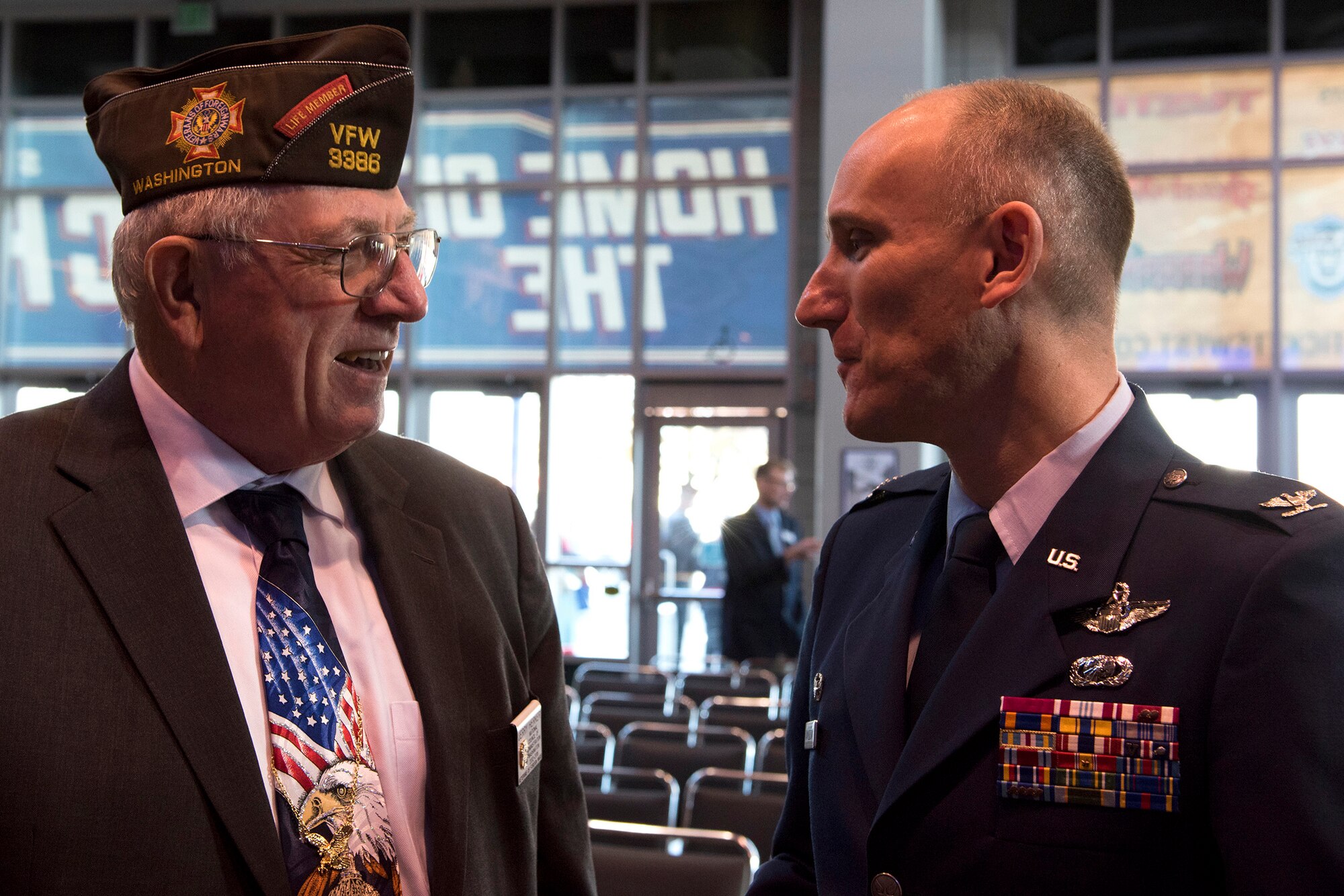 Col. Ryan Samuelson, 92nd Air Refueling Wing commander, speaks with Jerry Herker, Veterans of Foreign Wars Post 51 commander, during a Veterans Day ceremony Nov. 11, 2016, at the Spokane Arena. Samuelson spoke with local veterans and surviving family members of soldiers killed in the line of duty. (U.S. Air Force photo/Airman 1st Class Ryan Lackey)