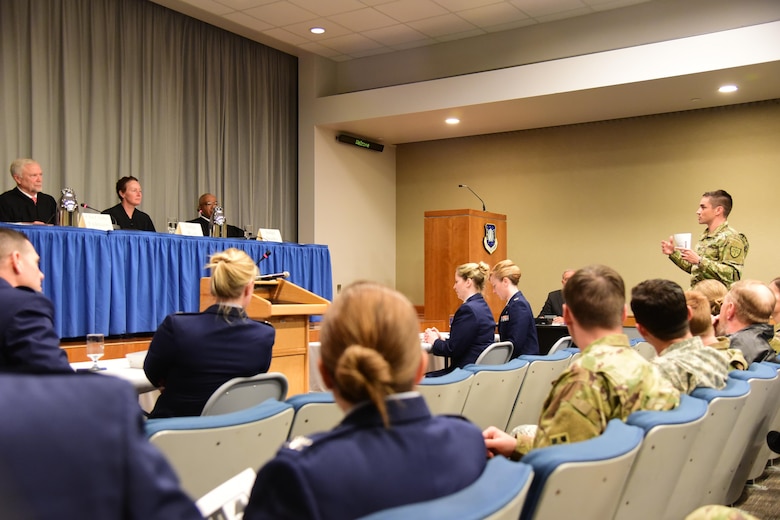 An audience member addresses the sitting judges of the United States Court of Appeals for the Armed Forces during the question and answer portion a hearing held at Peterson Air Force Base, Colo., Nov. 3, 2016. The appellate court was in town to preside over an appeal presented on behalf of Senior Airman Trentlee D. McClour, who petitioned the court to review whether or not there was an inconsistency in the initial proceedings of his case. (U.S. Air Force photo by Senior Airman Amber Grimm)