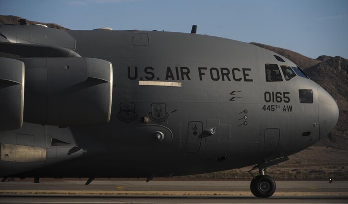 A C-17 Globemaster III taxis to the runway before takeoff during the Aviation Nation air show on Nellis Air Force Base, Nev., Nov. 11, 2016. The C-17 Globemaster III is the newest, most flexible cargo aircraft to enter the airlift force. It is capable of rapid strategic delivery of troops and varieties of cargo to main operating bases or directly to forward bases in the deployment area. (U.S. Air Force photo by Airman 1st Class Kevin Tanenbaum/Released)