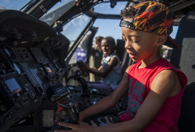 Children play with controls inside of an HH-60G Pave Hawk during the Aviation Nation air show on Nellis Air Force Base, Nev., Nov. 11, 2016. The primary mission of the HH-60G Pave Hawk helicopter is to conduct day or night personnel recovery operations into hostile environments to recover isolated personnel during war. The HH-60G is also tasked to perform military operations other than war, including civil search and rescue, medical evacuation, disaster response, humanitarian assistance, security cooperation/aviation advisory, NASA space flight support, and rescue command and control. (U.S. Air Force photo by Airman 1st Class Kevin Tanenbaum/Released)
