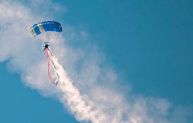 A member of the Wings of Blue Demonstration Team parachutes above spectators during the Aviation Nation Air Show on Nellis Air Force Base, Nev. Nov. 11, 2016. Each year, the Wings of Blue conduct more than 22,000 training jumps, awarding more than 700 jump wings to the students who pass through the Airmanship 490 program at the Academy.(U.S. Air Force photo by Airman 1st Class Kevin Tanenbaum/Released)