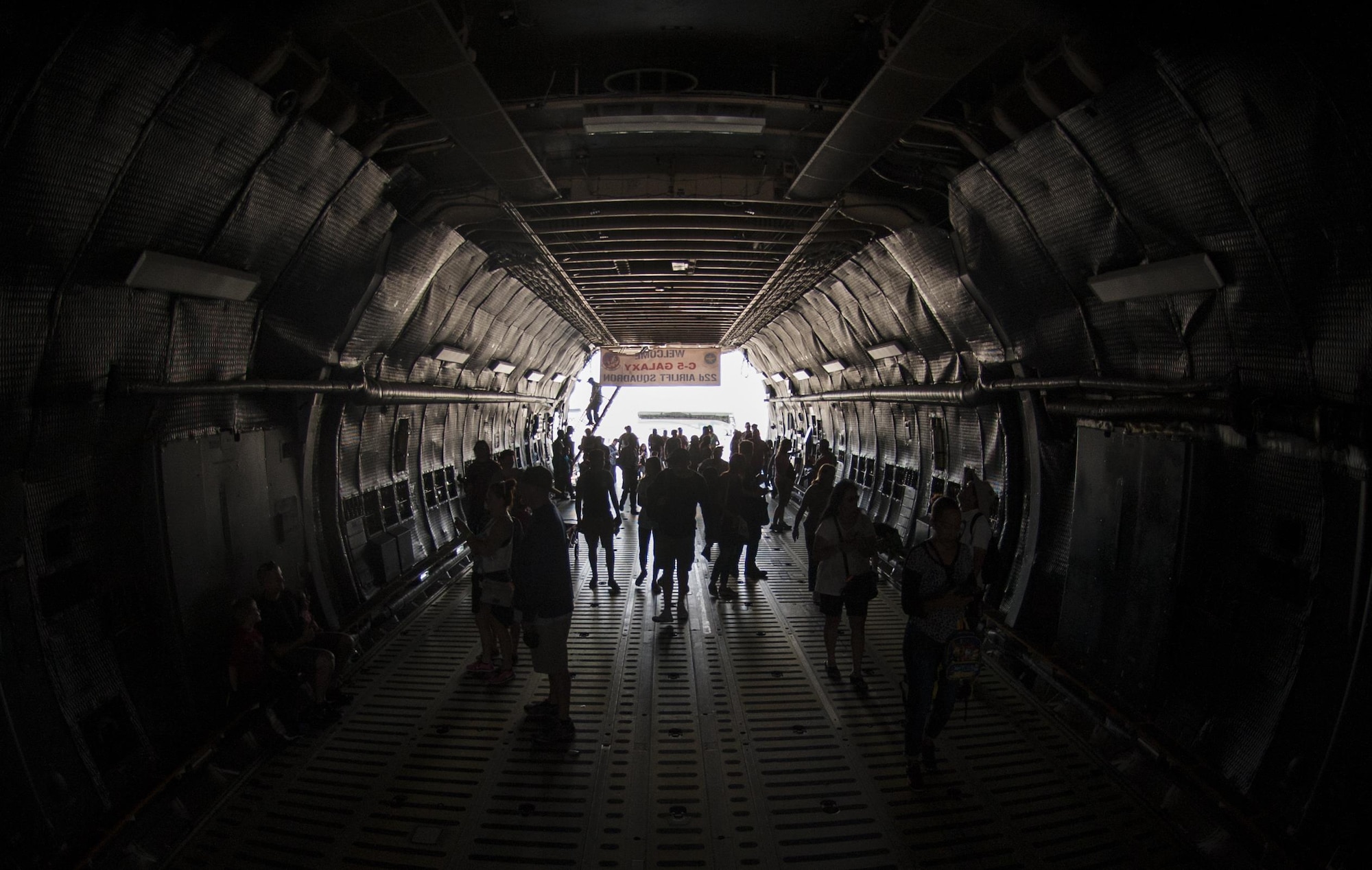 Guests of the Aviation Nation air show walk through a C-5 Galaxy during the Aviation Nation air show on Nellis Air Force Base., Nov. 12, 2016. The C-5 can carry a fully equipped combat-ready military unit to any point in the world on short notice and then provide the supplies required to help sustain the fighting force. (U.S. Air Force photo by Airman 1st Class Kevin Tanenbaum/Released)