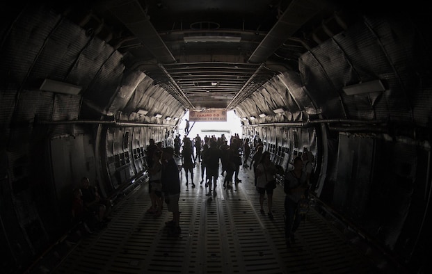 Guests of the Aviation Nation air show walk through a C-5 Galaxy during the Aviation Nation air show on Nellis Air Force Base., Nov. 12, 2016. The C-5 can carry a fully equipped combat-ready military unit to any point in the world on short notice and then provide the supplies required to help sustain the fighting force. (U.S. Air Force photo by Airman 1st Class Kevin Tanenbaum/Released)