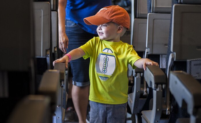 A young boy walks through the aisle of a KC-10 Extender during the Aviation Nation Air Show on Nellis Air Force Base, Nev., Nov. 12, 2016. The KC-10 Extender is an Air Mobility Command advanced tanker and cargo aircraft designed to provide increased global mobility for U.S. armed forces. (U.S. Air Force photo by Airman 1st Class Kevin Tanenbaum/Released)