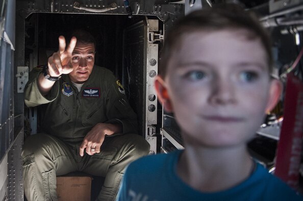 Maj. J. A. Meinhard, 7th Operations Group assistant director of operations, Dyess Air Force Base, Texas, shows a boy around the inside of a B-1 Lancer on Nellis AFB, Nev., Nov. 12, 2016. The multi-mission B-1 is the backbone of America's long-range bomber force. It can rapidly deliver massive quantities of precision and non-precision weapons against any adversary, anywhere in the world, at any time. (U.S. Air Force photo by Airman 1st Class Kevin Tanenbaum/Released)