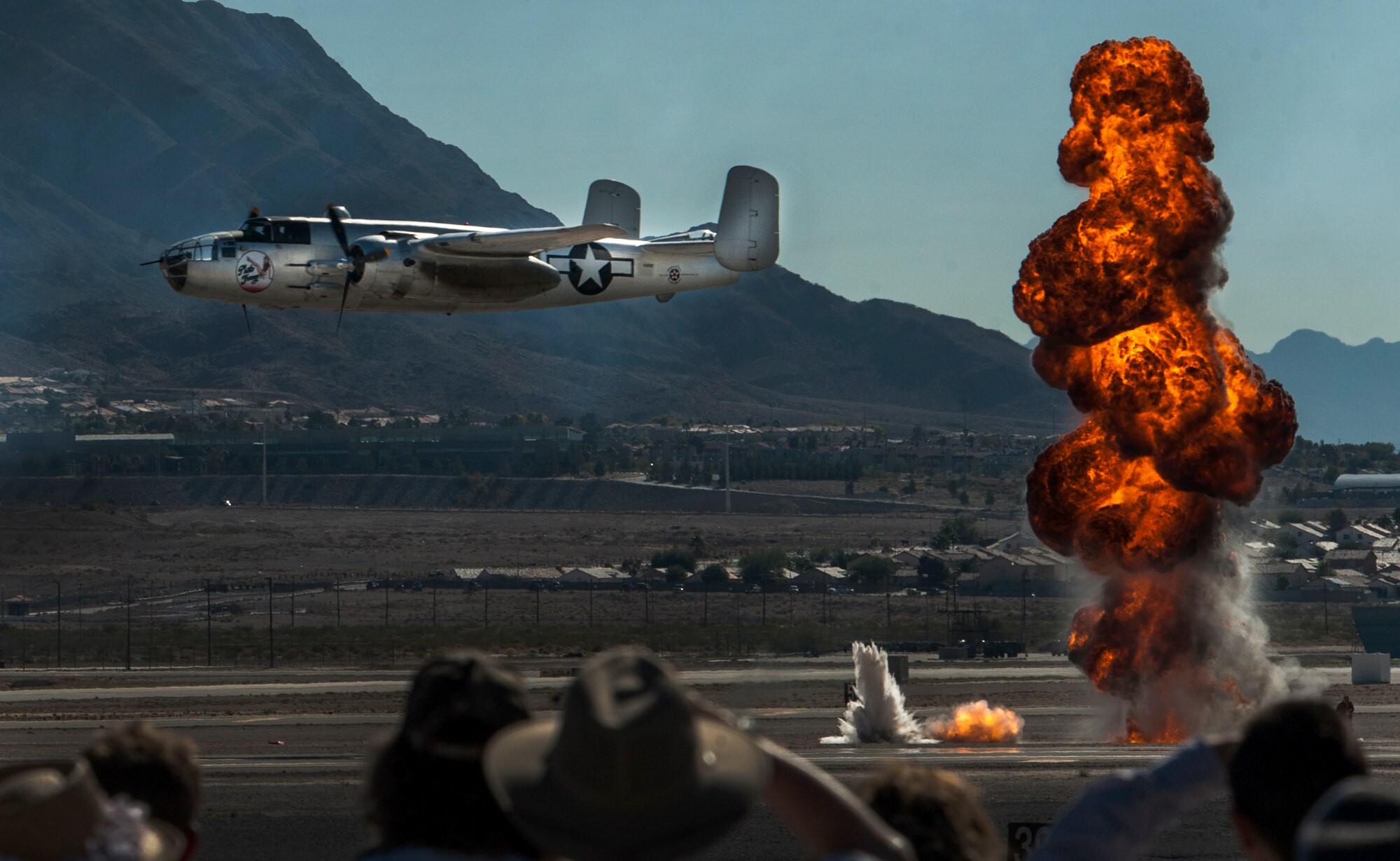 An aircraft flies in front of the crowd during an air-to-ground demonstration at the Aviation Nation air show on Nellis Air Force Base, Nev., Nov. 13, 2016. The many aerial acts and static aircraft displayed during the Nellis Air Show are snapshots of 75 years of aviation history. (U.S. Air Force photo by Airman 1st Class Kevin Tanenbaum/Released)