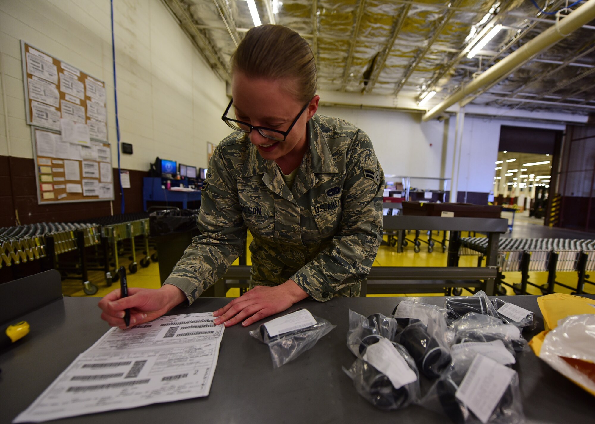 Airman 1st Class Justine Wilson, a traffic management journeyman assigned to the 28th Logistics Readiness Squadron, counts out the parts of a package received at Ellsworth Air Force Base, S.D., Nov. 8, 2016. Each part in a shipment must be accounted for to ensure the accuracy of the base inventory. (U.S. Air Force photo by Airman 1st Class James L. Miller) 