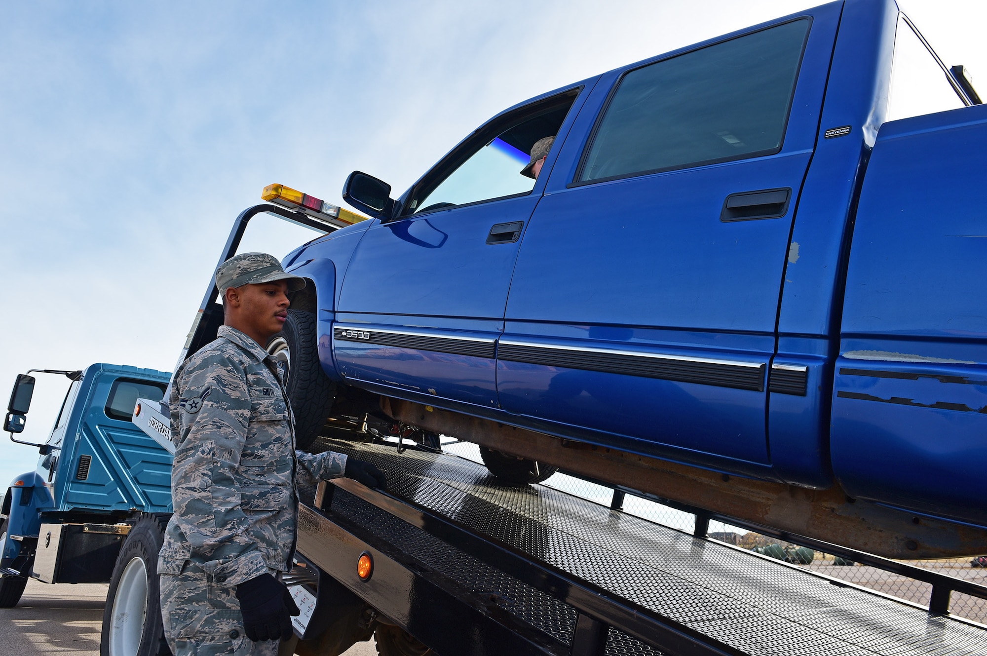 Airman 1st Class Jordan Smith, a vehicle operations apprentice assigned to the 28th Logistics Readiness Squadron, uses a winch to prepare a truck to be towed for repairs at Ellsworth Air Force Base, S.D., Nov. 8, 2016. Vehicle operators are responsible for ensuring the readiness of government vehicles on Ellsworth. (U.S. Air Force photo by Airman 1st Class James L. Miller)