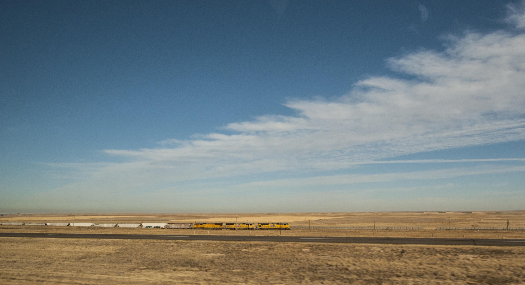 A Union Pacific train is passed by 320th Missile Squadron missileers traveling to a missile alert facility from F.E. Warren Air Force Base, Wyo., Nov. 5, 2016. Missileers can travel through up to three states to reach their assigned MAF. (U.S. Air Force Photo by Staff Sgt. Christopher Ruano) 