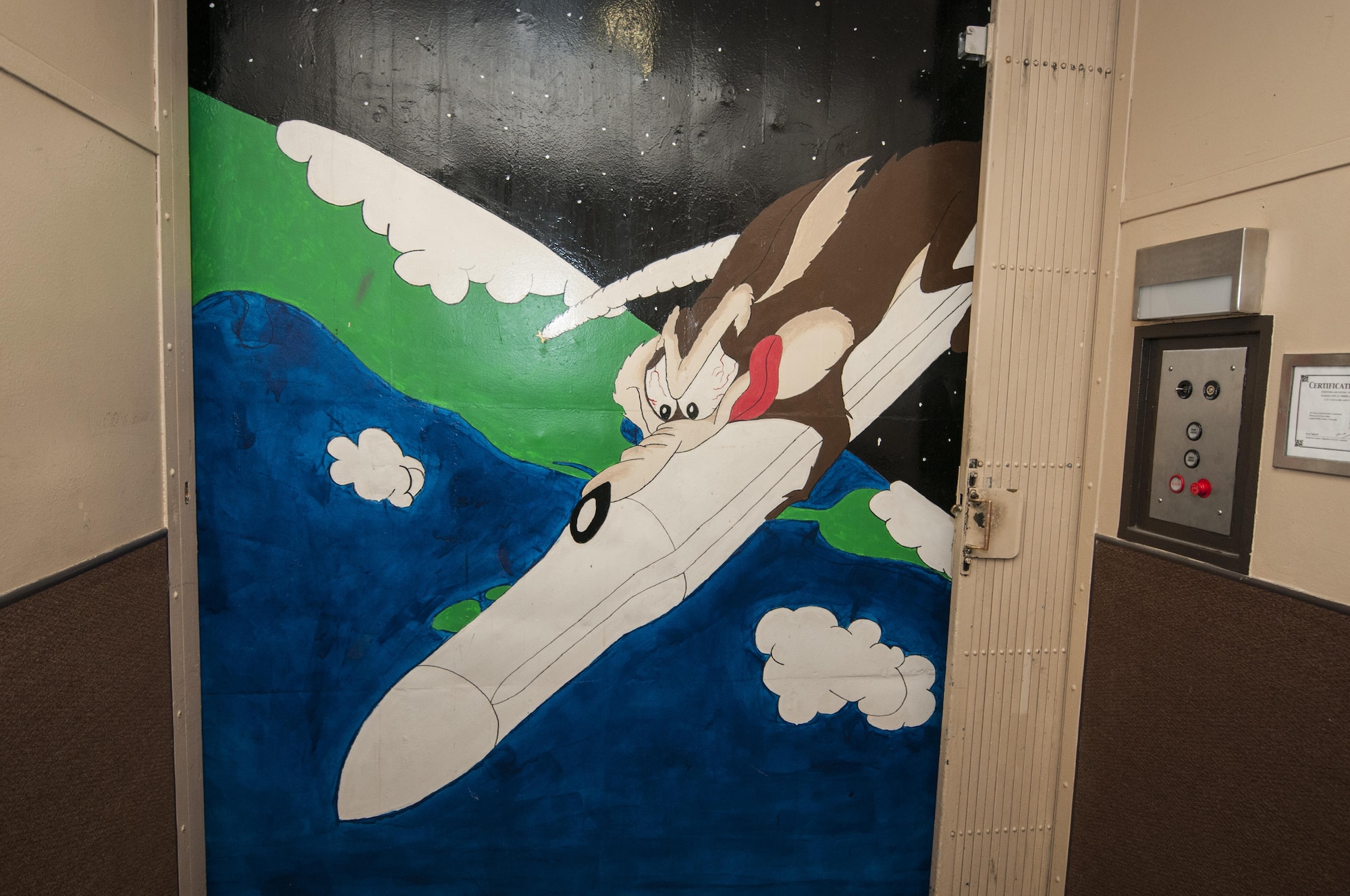 A mural depicting Loony Tune’s Wily E. Coyote is painted on the elevator shaft wall leading down into the launch control center at F.E. Warren Air Force Base, Wyo., Nov. 5, 2016. Each MAF has its own unique mural painted by fellow missileers. (U.S. Air Force photo by Staff Sgt. Christopher Ruano)