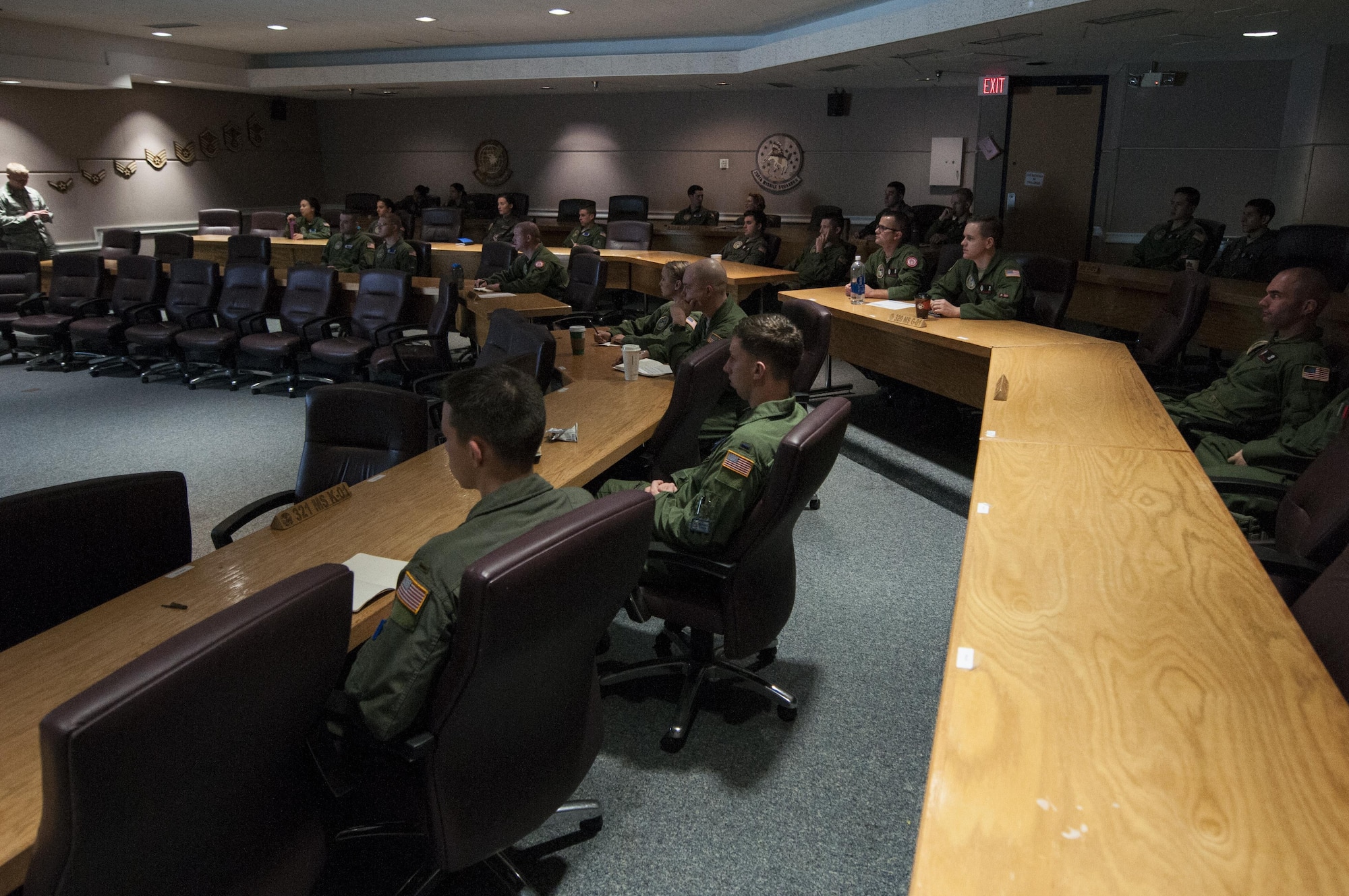 Missileers from the 90th Operations Group attend a pre-departure briefing at F.E. Warren Air Force Base, Wyo., Nov. 5, 2016. The briefing details the conditions of the 90th Missile Wing missile complex including weather forecasts and road conditions for their travel. (U.S. Air Force photo by Staff Sgt. Christopher Ruano)
