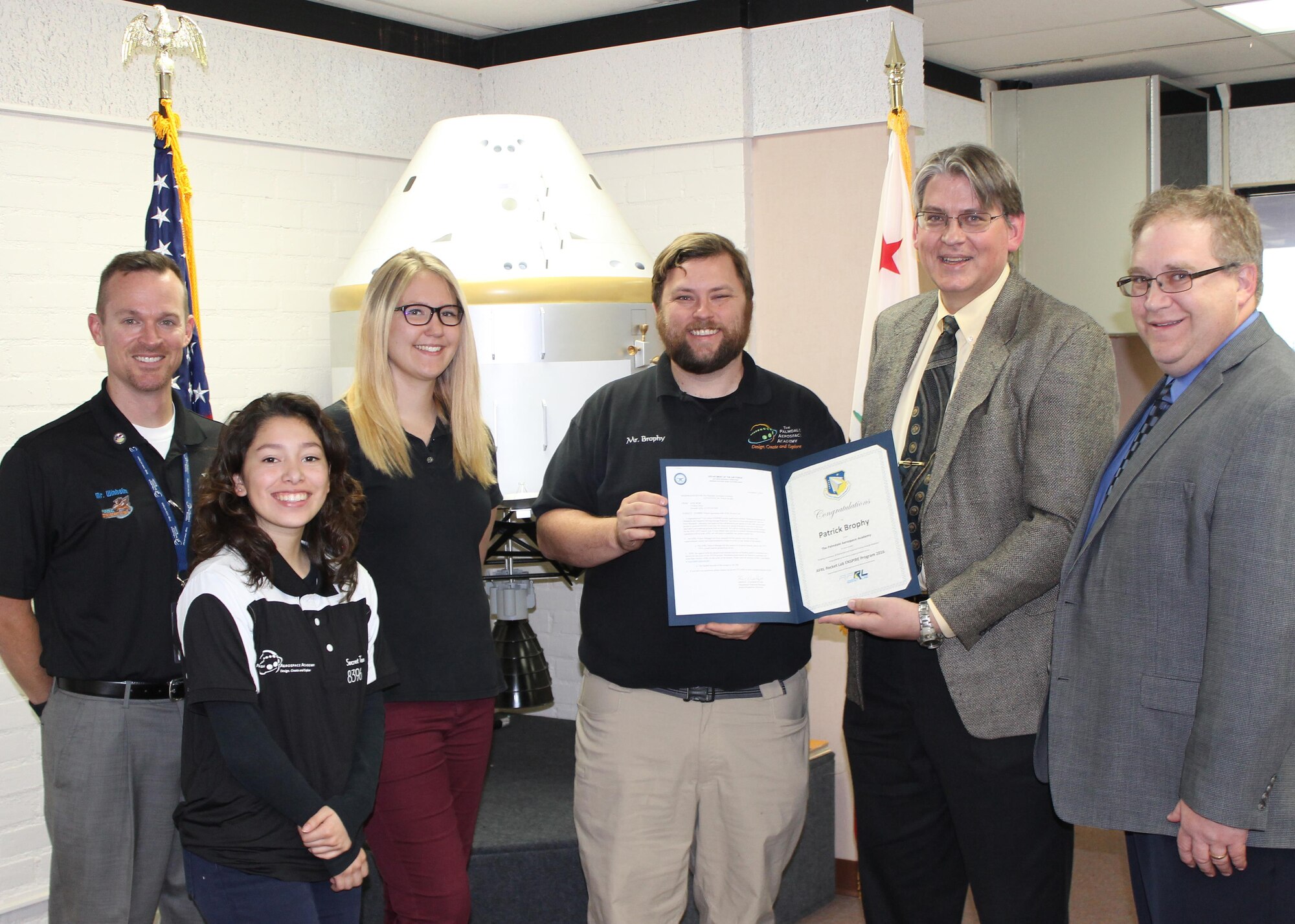 From left to right: Mathew Winheim, The Palmdale Aerospace Academy deputy headmaster; Priscilla Diaz, TPAA, student; Sarah Mellor, TPAA student; Patrick Brophy, TPAA math instructor; Kriss Vander Hyde, Air Force Research Laboratory Rocket Lab Educational Outreach manager; and Dr. Richard Cohn, AFRL Rocket Lab chief engineer; pose for a photo after Brophy was presented with an AFRL award for his project, “Building Awareness of Distracted and Impaired Driving through Robotics.”