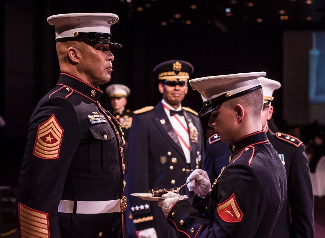 A cake ceremony is also an integral part of the Birthday Ball and includes a tradition of presenting the first piece of cake to the oldest Marine in attendance and then passed to the youngest Marine, representing the passing of tradition from one generation to another.

This year, MARFORK Commander MajGen Hedelund cut the cake, and the eldest attending Marine, MARFORK SgtMaj, SgtMaj Moran, passed his cake to the youngest attending Marine, LCpl Colin Read, who took the first bite.