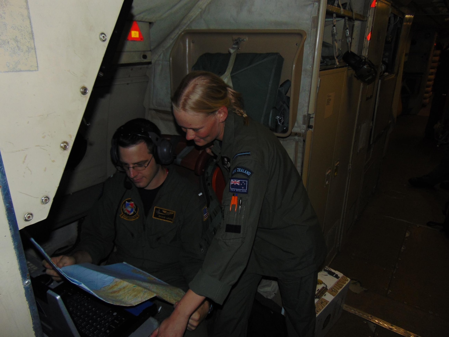 WHENUAPAI, New Zealand (Nov. 15, 2016) Lt. j.g. Shane Lewis, with the Golden Swordsmen of Patrol Squadron (VP) 47, examines a chart of New Zealand with an airman from the Royal New Zealand Air Force. The VP-47 crew and their U.S. Navy P-3C Orion aircraft are assisting in life-saving efforts after the Nov. 13 earthquakes on the South Island of New Zealand. (U.S. Navy photo by Lt. j.g Kyle Burdick/Released)