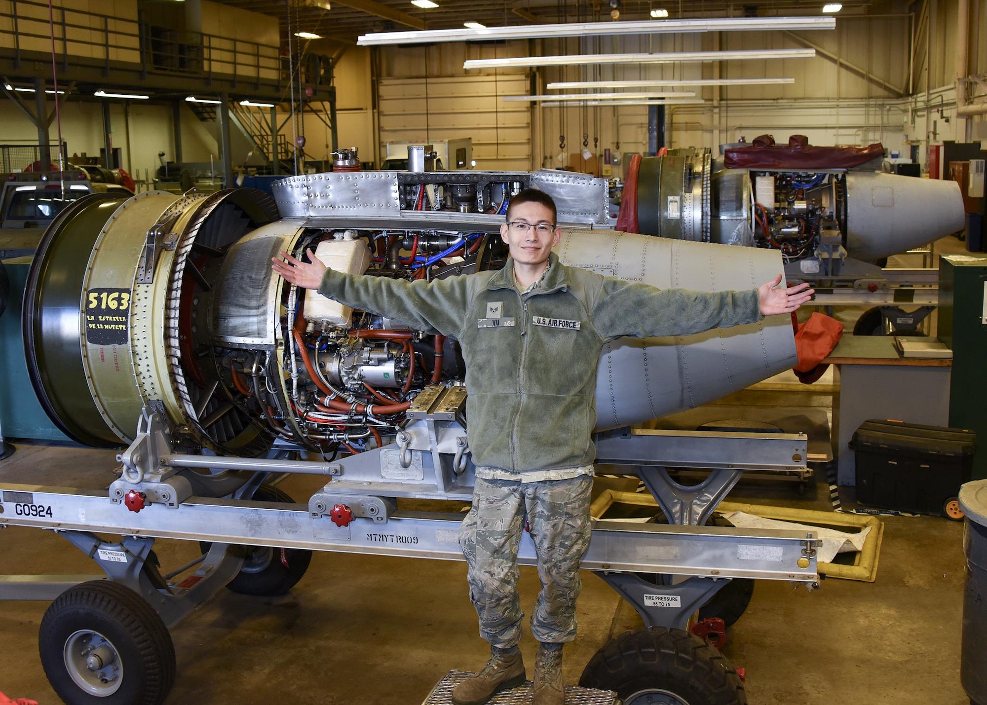 SrA Jimmy Vu poses in front of an A-10 engine Nov. 5, 2016 at Warfield Air National Guard Base, Middle River, Md. Vu is the Maryland Air National Guard November Spotlight Airman. (U.S. Air National Guard photo by Airman 1st Class Enjoli Saunders/RELEASED)