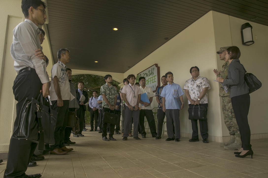 U.S. Army Col. Brady A. Crosier introduces himself to representatives of the Guntenkyo Nov. 11 during a presentation of the new Okinawa Orientation Overview aboard Camp Foster, Okinawa, Japan. The purpose of the orientation training is to familiarize new service members and civilians with Okinawa’s unique history and culture, and make them better informed about the environment where they will live and work. The new training is given to all service members and civilians on Okinawa and contains important historical examples, statistics and case studies based on recommendations from the Okinawa Prefectural Government. “We are at our best when we openly communicate, share ideas, and work with local leaders to prepare our Marines, Sailors, Airmen and soldiers to be ambassadors and respectful members of the communities we share in Okinawa,” said Marine Lt. Gen. Lawrence D. Nicholson, the Okinawa Area Coordinator for U.S. Forces, Japan. “We have worked hard to create an improved presentation that all the branches of the military can use to be more effective at building understanding within our shared communities.” Crosier is the chief of the Okinawa Area Field Office, USFJ.