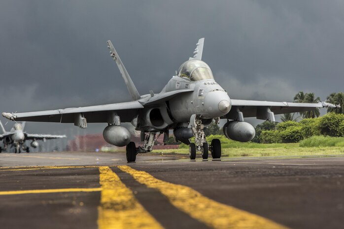 A U.S. Marine Corps F/A-18D Hornet with Marine All-Weather Fighter Attack Squadron (VMFA(AW)) 225 taxis down the flight line during exercise Cope West 17 at Sam Ratulangi International Airport, Indonesia, Nov. 10, 2016. This fighter-focused, bilateral exercise between the U.S. Marine Corps and Indonesian Air Force is designed to enhance the readiness of combined interoperability between the two nations. The squadron plans to complete their unit air-to-air training requirements, which focuses on basic fighter maneuvering, section engaged maneuvering, offensive anti-air warfare and active air defense versus the Indonesian Air Force to increase situational readiness, interoperability, knowledge and partnership between the U.S. and Indonesia. (U.S. Marine Corps photo by Cpl. Aaron Henson)