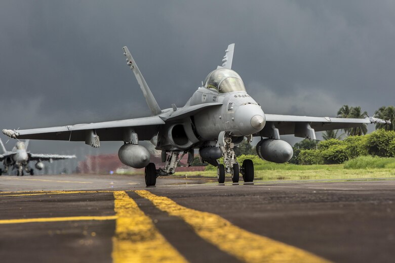 A U.S. Marine Corps F/A-18D Hornet with Marine All-Weather Fighter Attack Squadron (VMFA(AW)) 225 taxis down the flight line during exercise Cope West 17 at Sam Ratulangi International Airport, Indonesia, Nov. 10, 2016. This fighter-focused, bilateral exercise between the U.S. Marine Corps and Indonesian Air Force is designed to enhance the readiness of combined interoperability between the two nations. The squadron plans to complete their unit air-to-air training requirements, which focuses on basic fighter maneuvering, section engaged maneuvering, offensive anti-air warfare and active air defense versus the Indonesian Air Force to increase situational readiness, interoperability, knowledge and partnership between the U.S. and Indonesia. (U.S. Marine Corps photo by Cpl. Aaron Henson)