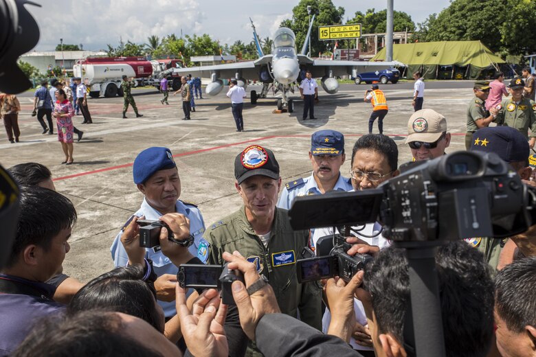 Indonesian media interview U.S. Air Force Maj. Gen. Mike Compton, Air National Guard assistant to the commander, Pacific Air Forces, during a closing ceremony for exercise Cope West 17 at Sam Ratulangi International Airport, Indonesia, Nov. 11, 2016. First conducted in 1989, Cope West is a Pacific Air Force lead exercise, normally focusing on airlift, air-land and air drop delivery operation techniques. Cope West 17 is the first fighter-focused exercise in Indonesia in 19 years involving the U.S. Military and the Indonesian Air Force. (U.S. Marine Corps photo by Cpl. Aaron Henson)