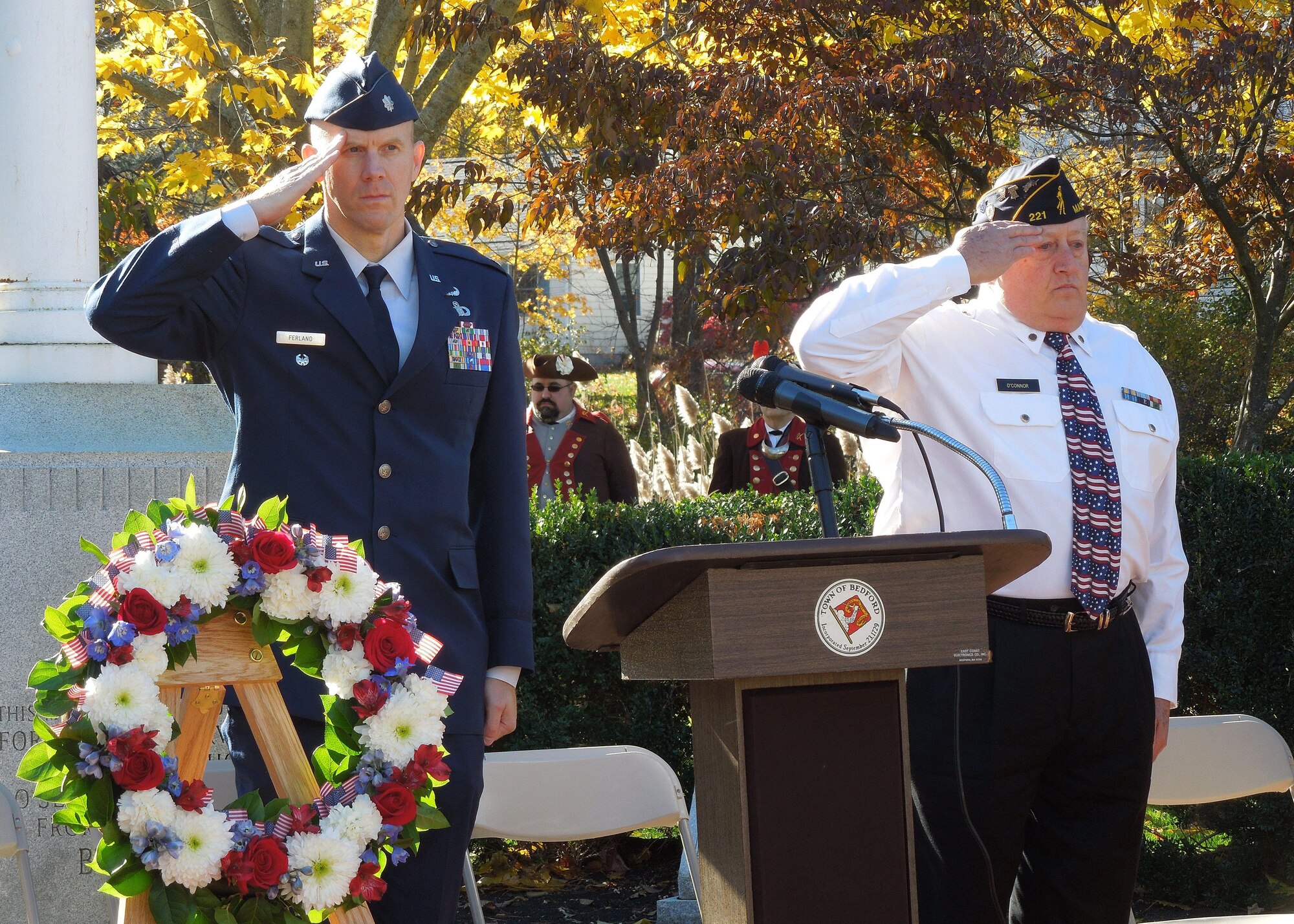 Lt. Col. Kenneth A. Ferland, 66th Air Base Group deputy commander, and Jon O'Connor, commander of American Legion Post 221, salute as the national anthem plays during a Veterans Day ceremony in Bedford, Mass., Nov. 11. Several local towns surrounding Hanscom honored military service members during Veterans Day observances. (Courtesy photo)  
