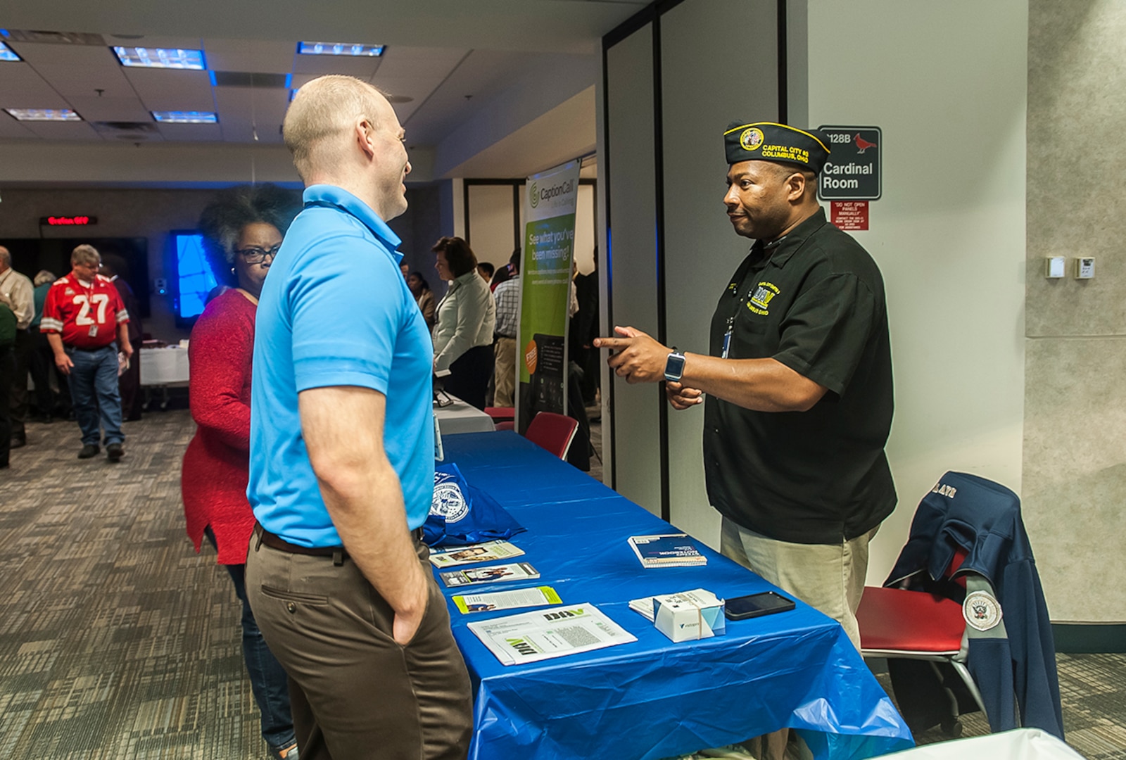 A representative from the Disabled American Veterans talks to a DSCC associate about what the charity offers during a Veterans Benefits fair Nov. 9 inside the DLA land and Maritime Operations Center.