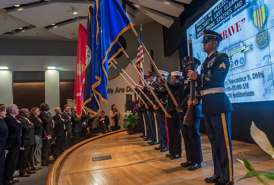 Members of the DSCC Joint Service Color Guard Team present the colors to kick off the annual Veterans Day Program Nov. 9 inside the DLA Land and Maritime Operations Center auditorium.