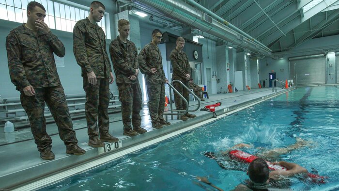 Marines watch Sgt. Sasha McFadden as he explains a buddy rescue drill during an advanced water survival course at Camp Lejeune, N.C., Nov. 8, 2016. The course was aimed toward qualifying Marines as advanced swimmers, the highest level in the Marine Corps Water Survival Training Program. 