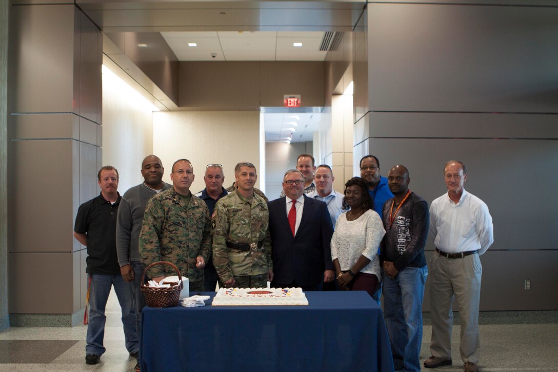 DLA Distribution commanding general, Army Brig. Gen. John S. Laskodi is joined by current and former Marines during the 241st Marine Corps birthday celebration on Nov. 10. 