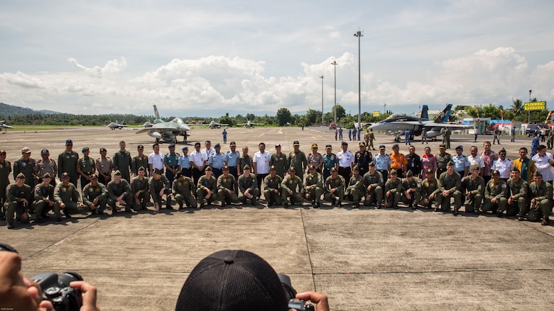 U.S. Marines with Marine All-Weather Fighter Attack Squadron 225, U.S. Air Force Maj. Gen. Mike Compton, Air National Guard assistant to the commander, Pacific Air Forces, Indonesian Air Force service members and Indonesian Air Vice Marshal Barhim, Air Force Chief Operations Assistant, pose for a photo during a closing ceremony for exercise Cope West 17 at Sam Ratulangi International Airport, Indonesia, Nov. 11, 2016. This fighter-focused, bilateral exercise between the U.S. Marine Corps and Indonesian Air Force is designed to enhance the readiness of combined interoperability between the two nations.