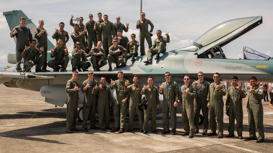 U.S. Marines with Marine All-Weather Fighter Attack Squadron 225 and Indonesian Air Force service members pose for a photo with an Indonesian Air Force F-16 Fighting Falcon during a closing ceremony for exercise Cope West 17 at Sam Ratulangi International Airport, Indonesia, Nov. 11, 2016. The combined training offered by this exercise helps prepare the U.S. Marine Corps and Indonesia Air Force to work together in promoting a peaceful Indo-Asia-Pacific region while practicing close air support and air-to-air training that will enhance their ability to respond to contingencies throughout the region.
