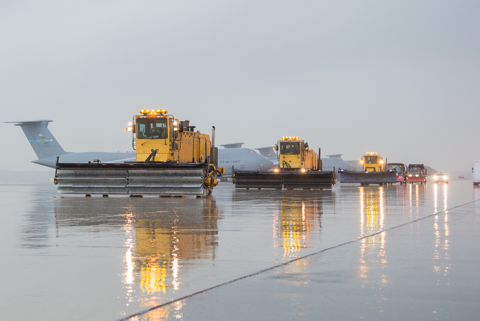 A line of snow removal vehicles belonging to the 436th Civil Engineer Squadron drive down the flightline during the snow parade Nov. 9, 2016, on Dover Air Force Base, Del. Held every fall, the parade familiarizes unit commanders with the snow removal process and ensures staff members and equipment are ready for the winter season. (U.S. Air Force photo by Mauricio Campino)