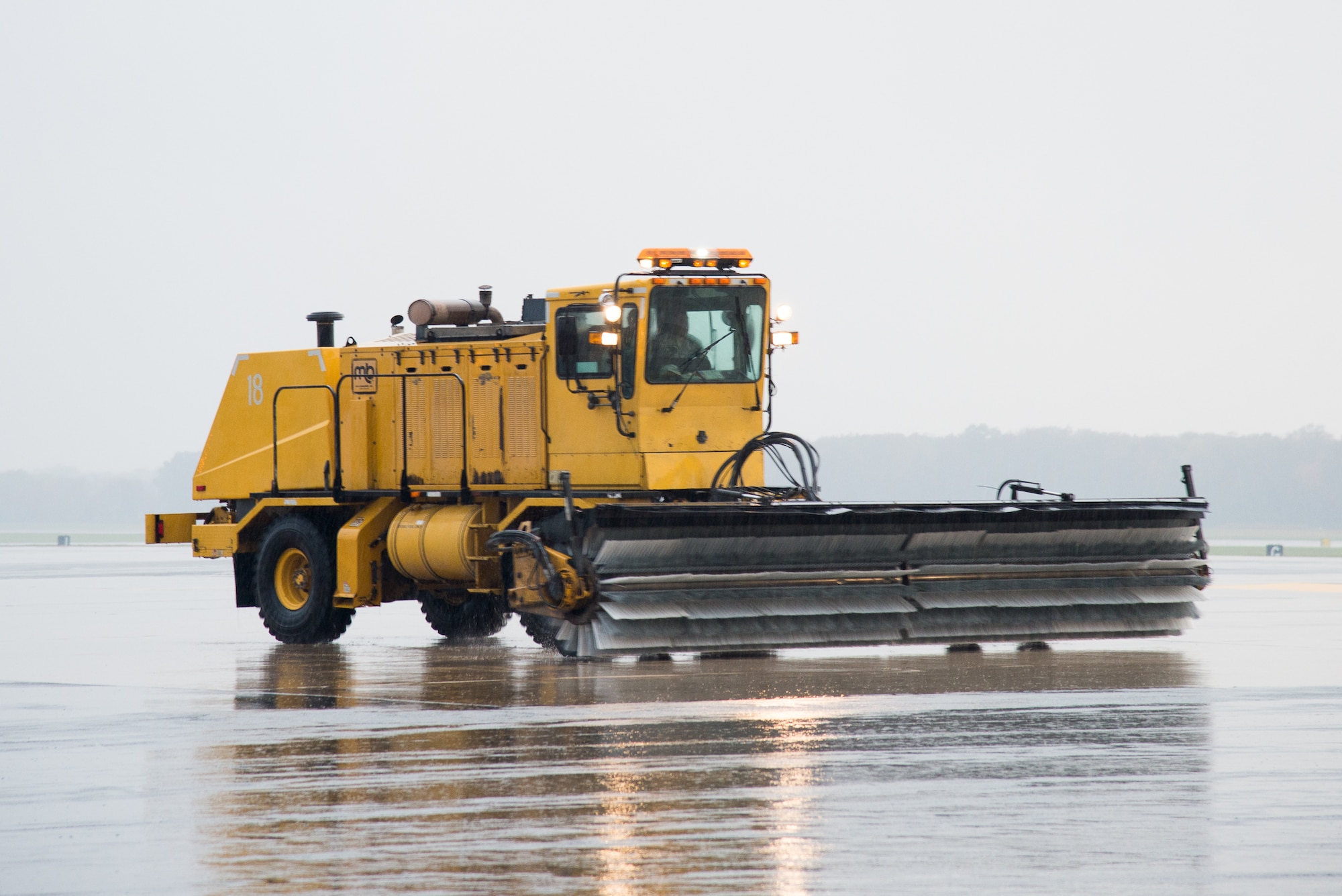 A snow removal vehicle belonging to the 436th Civil Engineer Squadron drives down the flightline during the snow parade Nov. 9, 2016, on Dover Air Force Base, Del. The parade ensures staff members and equipment are ready for the coming winter season and offers unit commanders an opportunity to get familiar with the snow removal process. (U.S. Air Force photo by Mauricio Campino)