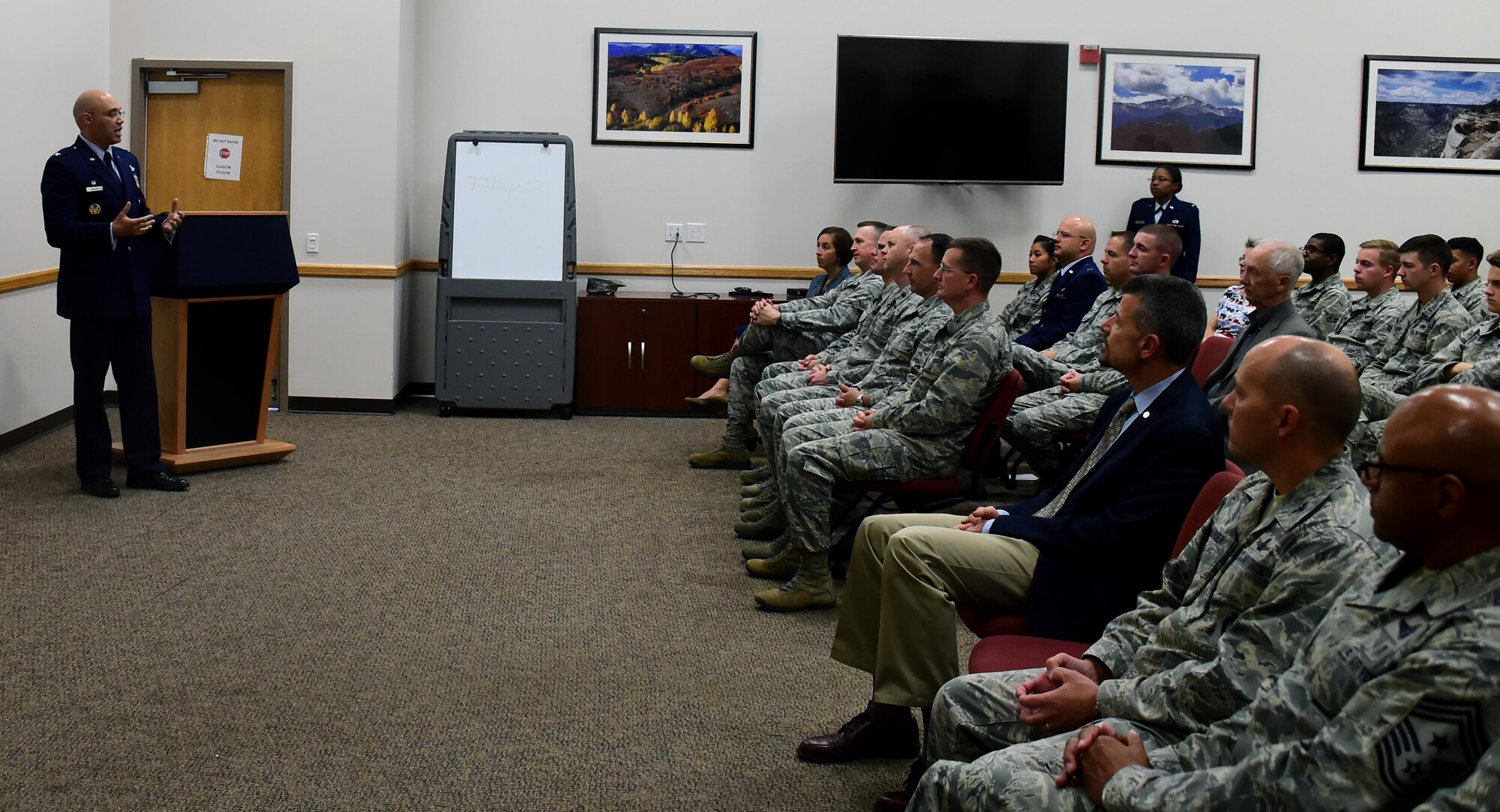 Col. David Miller, 460th Space Wing commander, addresses the audience for closing remarks, Nov. 10, 2016, at Buckley Air Force Base, Colo.  Members of Team Buckley gathered for a short Veterans Day speech presented by Chief Master Sgt. (ret.) Rene Simard, a prior command chief at Buckley AFB. (U.S. Air Force photo by Airman Holden S. Faul/ Released)