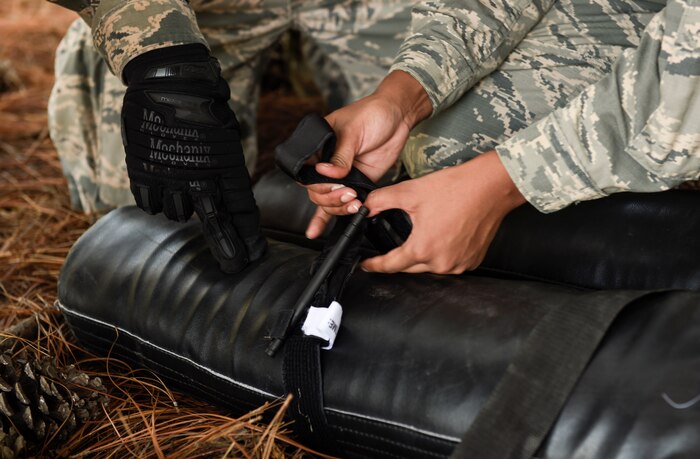 U.S. Air Force Staff Sgt. Max Rasmussen, 628th Medical Group member and Airman 1st Class Adaijah Rouse-Powell, 628th Force Support Squadron member, apply a tourniquet to a simulated casualty during the first Joint Base Charleston Combat Skills Training course here, Sept. 28, 2016. Feedback from members, hand selected to participate in the course, assisted base leadership and CST instructors determine how to improve the course for future Team Charleston service members.