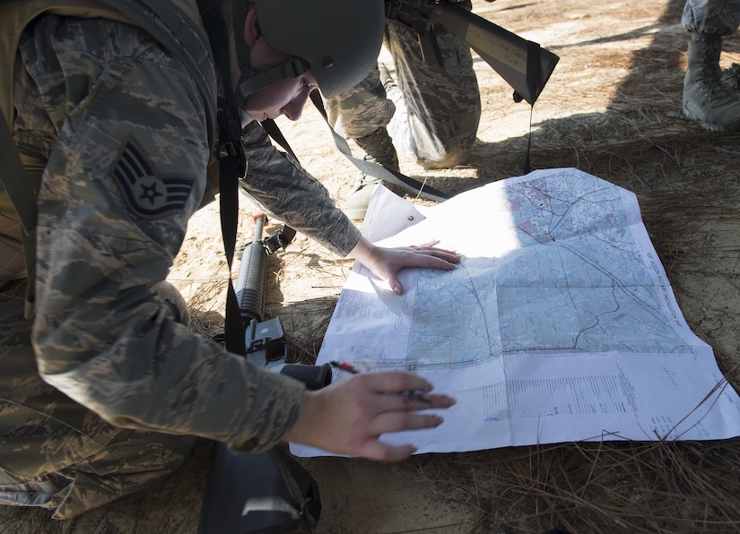 U.S. Air Force Staff Sgt. Michele Lazurka, 628th Medical Support Squadron member, plots coordinates on a map during the first Joint Base Charleston Combat Skills Training course here, Sept. 28, 2016. The four day course trained Airmen on basic tactical combat skills such as: weapons training, combat life saver skills, counter improvised explosive device tactics, communications and land navigation.