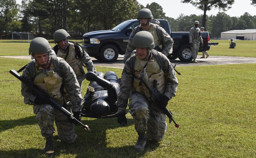 Joint Base Charleston Airmen carry a litter with a simulated casualty during the first JB Charleston Combat Skills Training course here, Sept. 28, 2016. The intent of CST is to ensure Airmen possibly deploying to hostile theaters in support of the joint service operations have the knowledge, skills and abilities to survive and support the mission in and out of combat. 