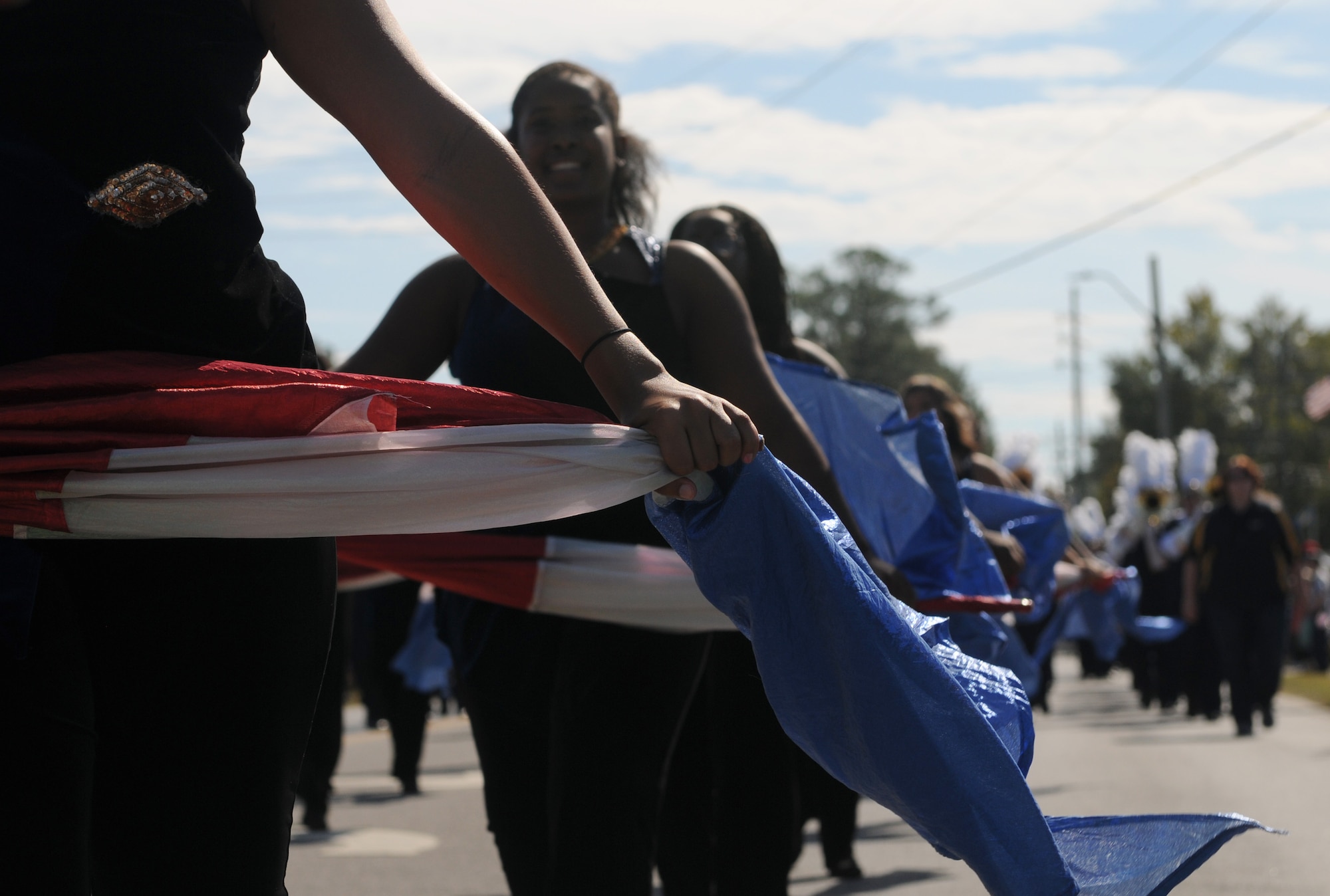 Mississippi Gulf Coast Community College Band of Gold color guard members march in the 16th Annual Gulf Coast Veterans Day Parade Nov. 12, 2016, in D’Iberville, Miss. More than 5,000 Mississippi and Louisiana citizens watched the parade honoring Gulf Coast veterans. Keesler Honor Guard members, base leadership and more than 215 81st Training Group Airmen with the 50 State Flag Team and Drum and Bugle Corps also came out to celebrate the holiday. (U.S. Air Force photo by Senior Airman Holly Mansfield)