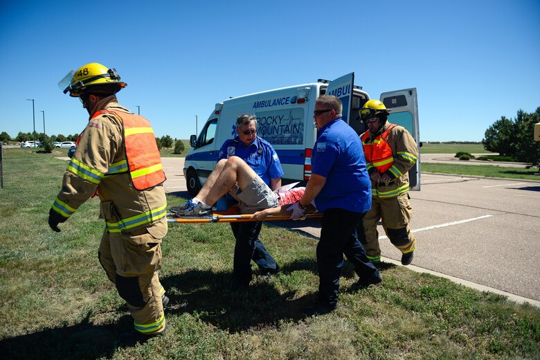 SCHRIEVER AIR FORCE BASE, Colo. – Schriever Air Force Base firefighters work with Rocky Mountain Medical to transport a victim during a simulated emergency at Schriever Air Force Base, June 15, 2016. The fire department is required to train annually with their mutual aid partners, but an effort is made to conduct joint training more often (U.S. Air Force photo/Christopher DeWitt)