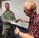Staff Sgt. Victor Blazevic, 339th Recruiting Squadron enlisted accessions recruiter helps Karl Sickels, a teacher at Porter County Career Center in Valporaiso, Ind., draw the winner of an Air Force backpack at the end of Blazevic's presentation.
