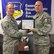 Senior Master Sgt. Dale Graham, 339th Recruiting Squadron production superintendent presents Staff Sgt. Victor Blazevic, 339th RCS enlisted accessions recruiter, with his recruiter certification.