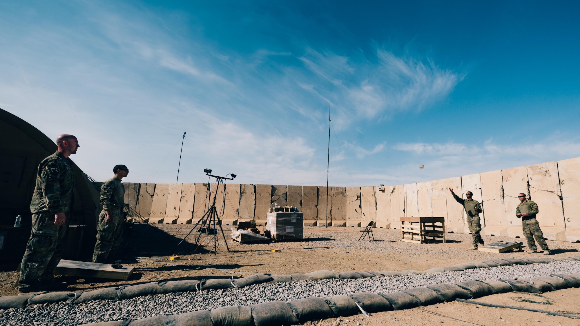Airmen with the 821st Contingency Response Group play corn hole with makeshift boards and bags during downtime at Qayyarah West Airfield, Iraq, Nov. 13, 2016. The airfield at Qayyarah West was recaptured from Da’esh by Iraqi forces in July 2016, and has been refurbished by Coalition engineers to allow the re-commencement of air operations. Qayyarah Airfield is now a vital logistical hub, opening an air corridor in support of the battle to liberate Mosul as well as operations throughout northern Iraq. (U.S. Air Force photo by Senior Airman Jordan Castelan)