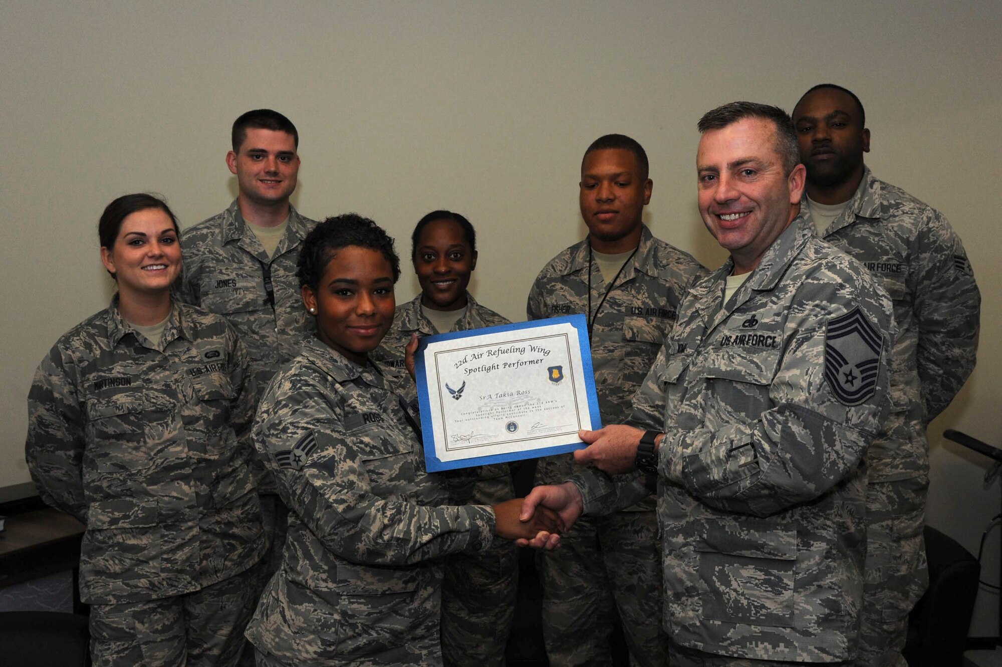 Senior Airman Takia Ross, 22nd Aircraft Maintenance Squadron commander support staff, poses with Chief Master Sgt. Thomas, 22nd AMXS superintendent, Nov. 16, 2016, at McConnell Air Force Base, Kan. Ross received the spotlight performer for the week of Oct. 17-21. (U.S. Air Force photo/Airman 1st Class Jenna K. Caldwell) 