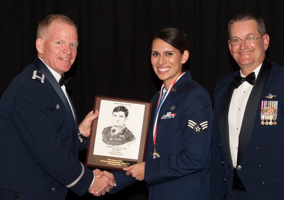 Senior Airman Lizzette Kriner, with the 3rd Flying Training Squadron, accepts the John L. Levitow Award from Col. Darrell Judy, left, 71st Flying Training Wing commander, during the Airman Leadership School Class 17A graduation ceremony Nov. 9 at the Vance Collocated Club, Vance Air Force Base, Oklahoma. To the right is Chief Master Sgt. Jeffrey Wilson, the 71st FTW command chief. The Levitow Award is the most prestigious award an Airman can earn in enlisted professional military education. (U.S. Air Force photo/ Tech. Sgt. James Bolinger)