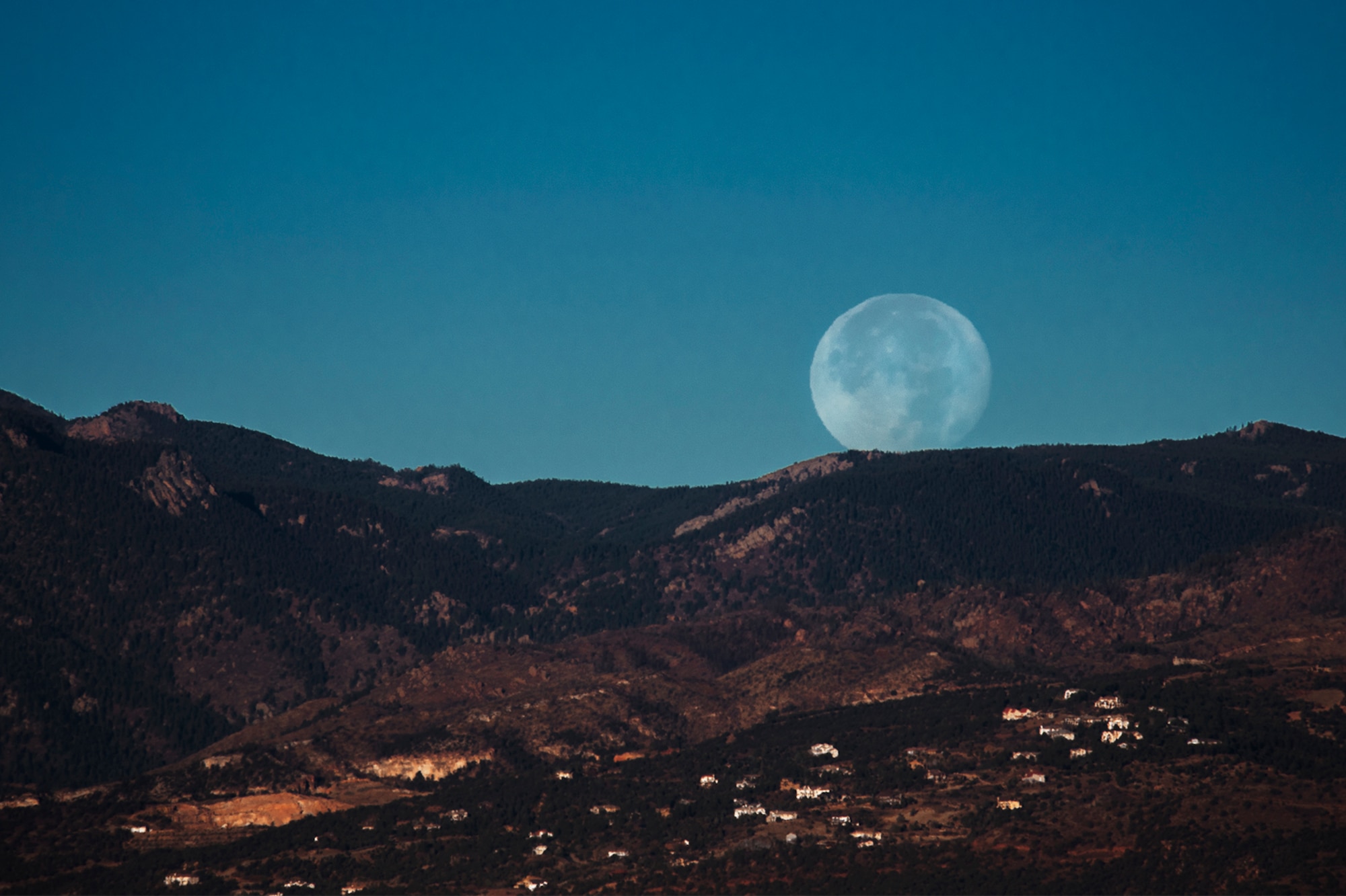 PETERSON AIR FORCE BASE, Colo. – A supermoon sets over the front range of the Rocky Mountains, Colo., Nov. 15, 2016. A supermoon is a coincidence of a full moon or a new moon with the closest approach the moon makes to the Earth on its elliptical orbit. (U.S. Air Force photo by Airman 1st Class Dennis Hoffman)